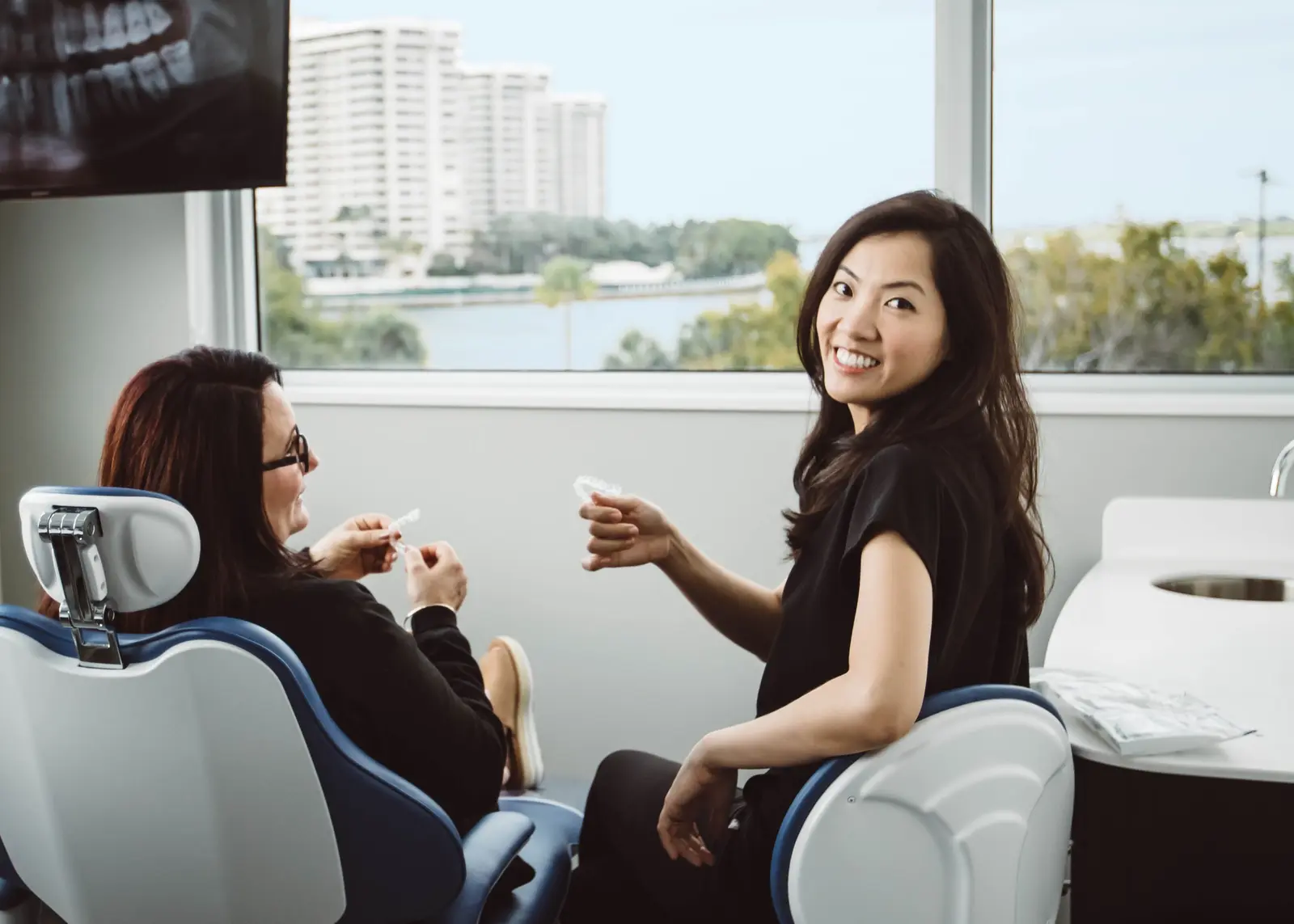 Dr. Patricia Hong with a patient in a treatment room overlooking Biscayne Bay