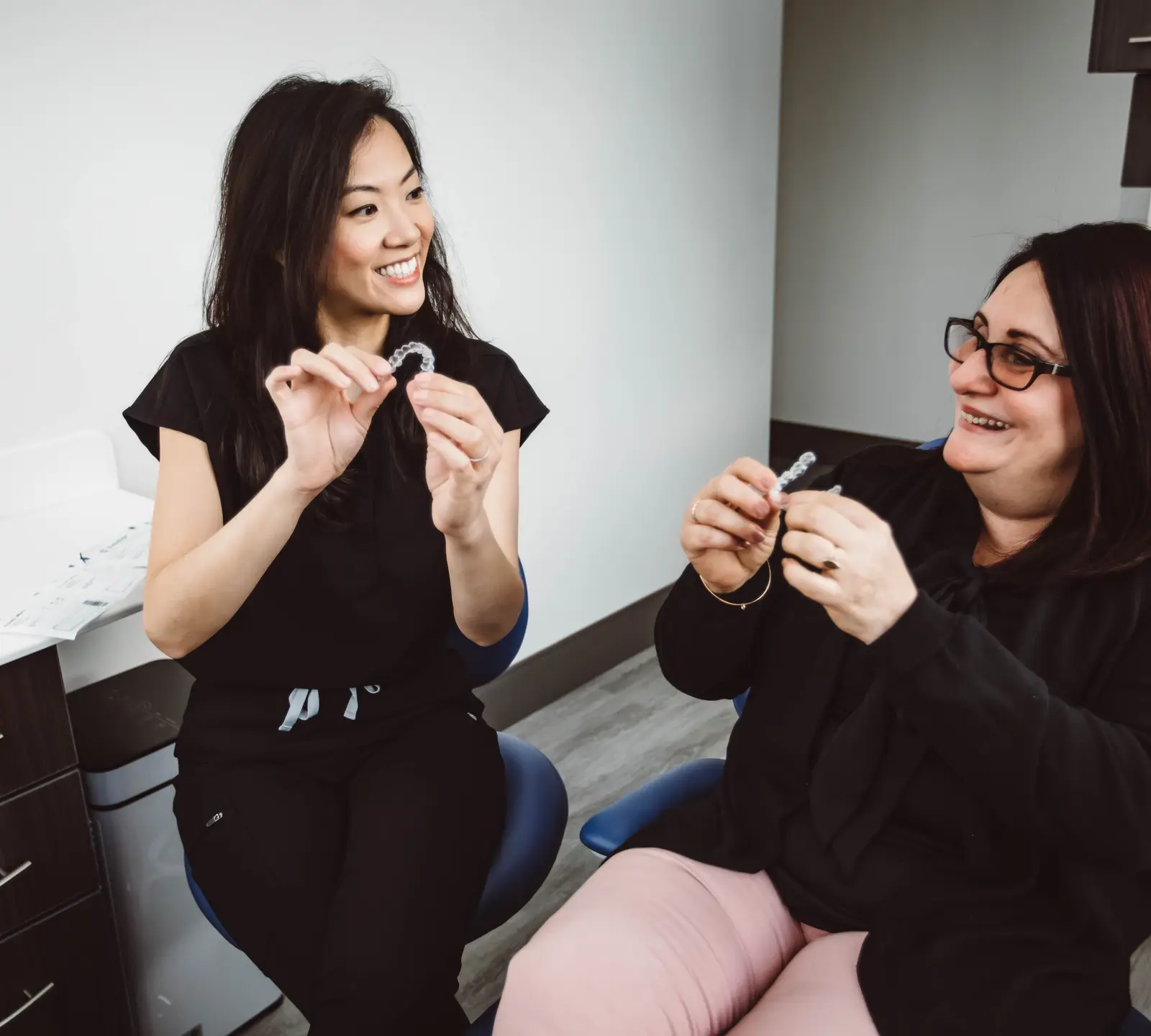 Dr. Patricia Hong showing Invisalign clear aligners to a patient