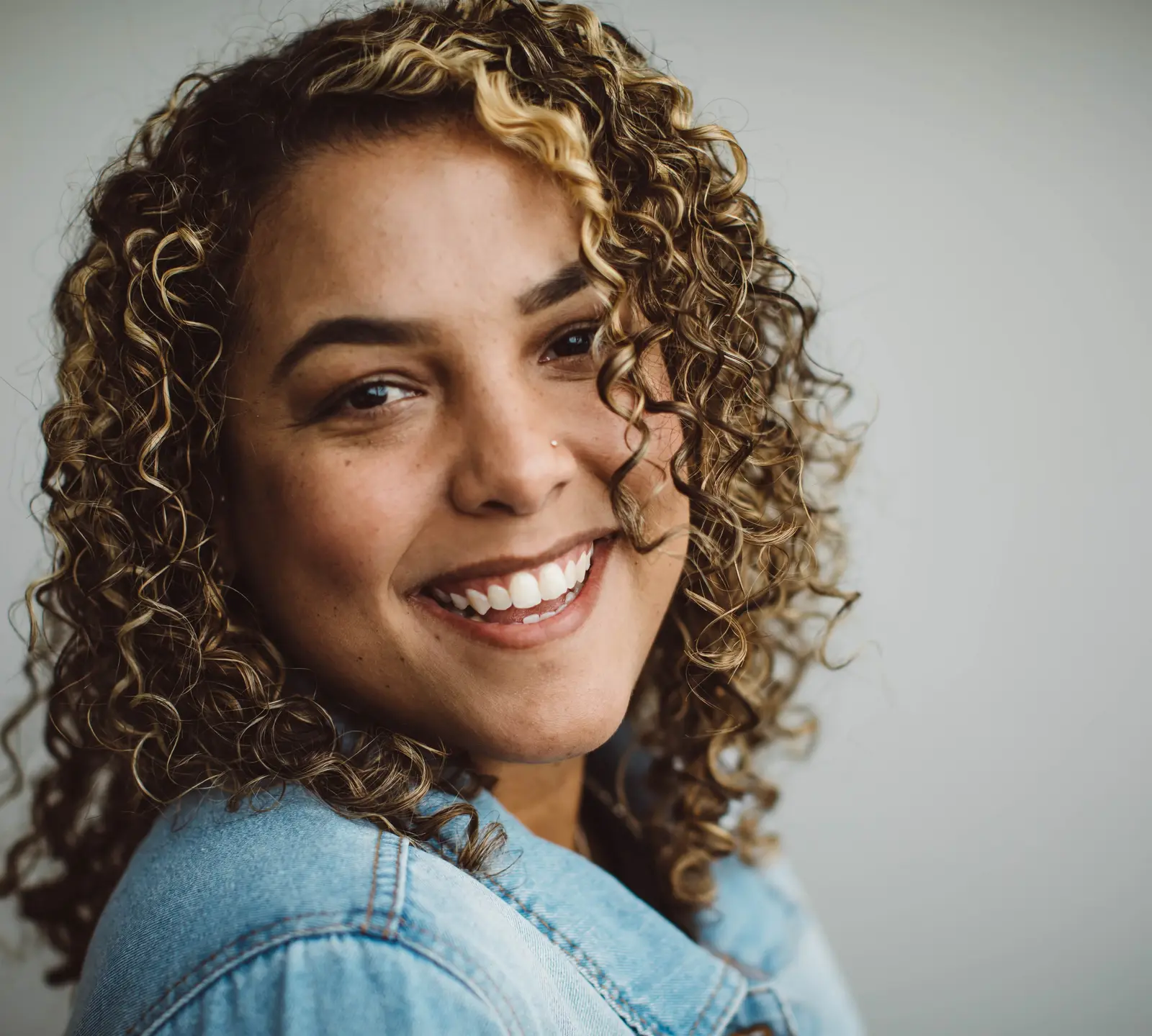 A woman smiling after cosmetic dentistry at Vizcaya Dental Arts